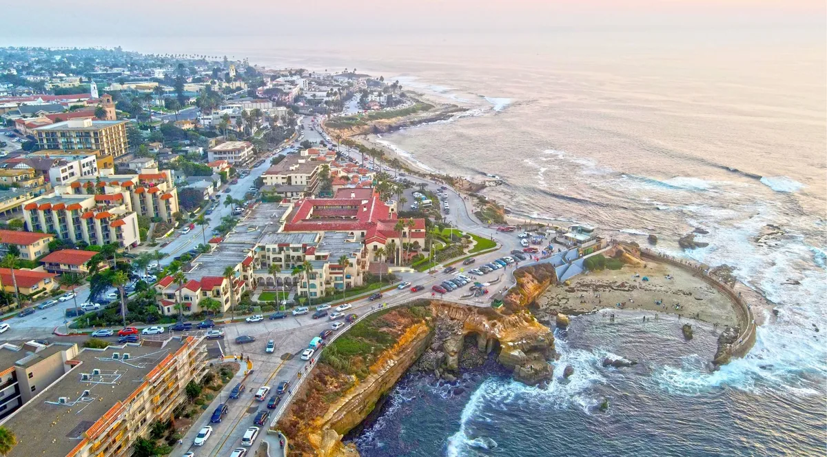 Aerial view of La Jolla Village and Coast Boulevard, both kerbs lined solid with parked cars